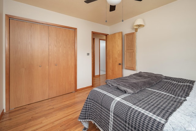 bedroom with light hardwood / wood-style floors, a closet, and ceiling fan