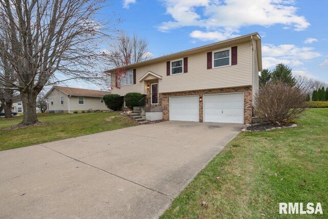 bi-level home featuring a garage and a front yard