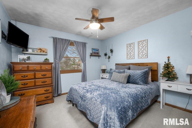 bedroom featuring light colored carpet and ceiling fan