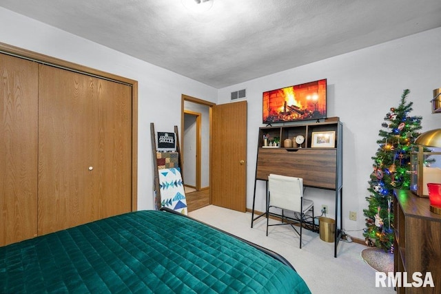 carpeted bedroom with a closet