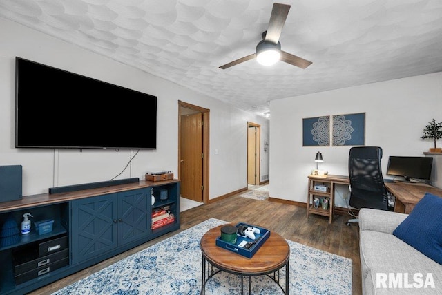 living room with ceiling fan, dark hardwood / wood-style flooring, and a textured ceiling