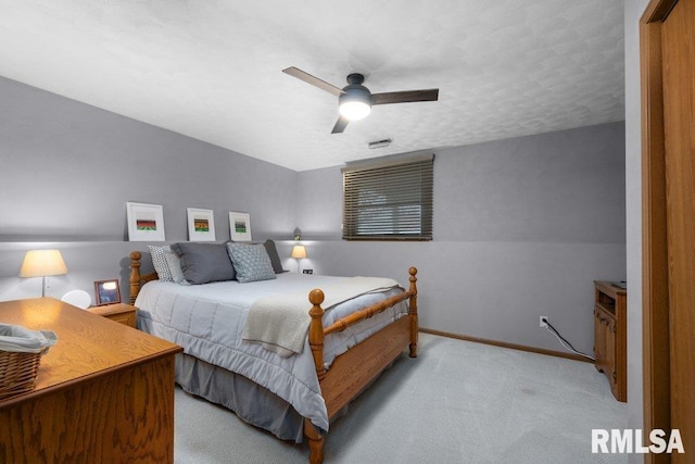 bedroom featuring light carpet and ceiling fan