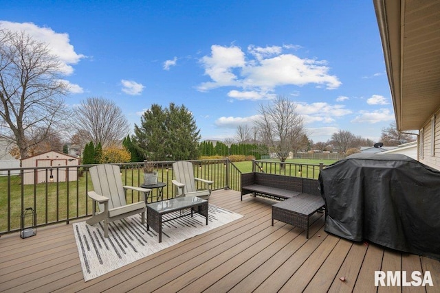 wooden terrace featuring area for grilling, an outdoor hangout area, and a lawn