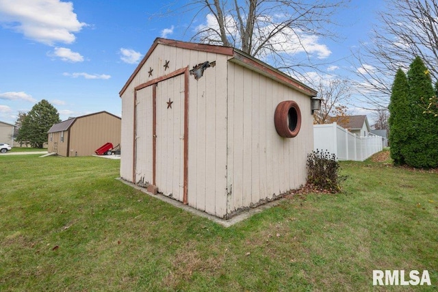 view of outbuilding featuring a yard