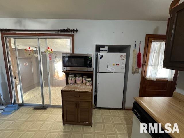 kitchen with stainless steel appliances and dark brown cabinetry