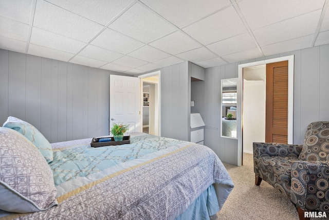 carpeted bedroom with a drop ceiling