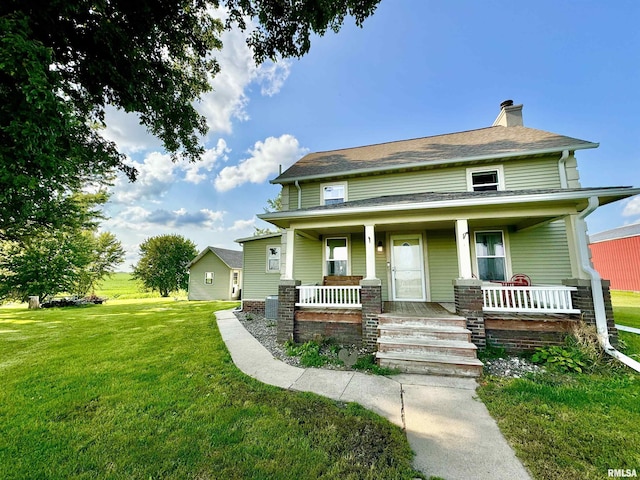 view of front facade with a porch, a front yard, and central air condition unit