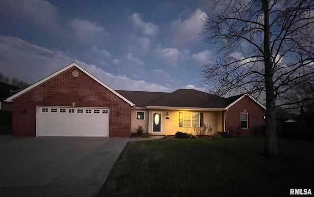 single story home featuring a garage and a yard