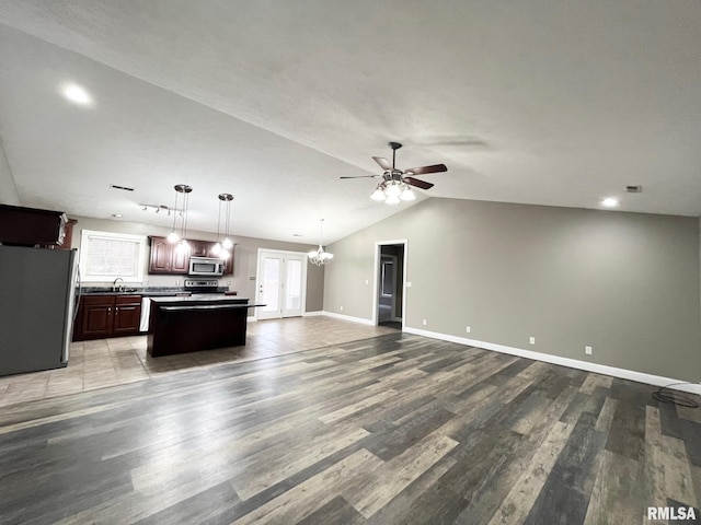 kitchen featuring sink, a kitchen island, pendant lighting, stainless steel appliances, and hardwood / wood-style floors