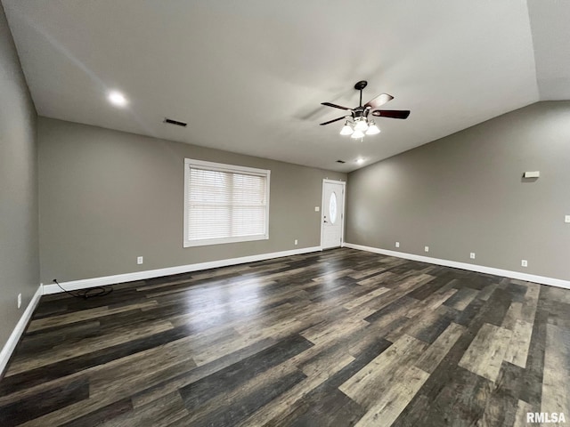 unfurnished room with dark hardwood / wood-style flooring, lofted ceiling, and ceiling fan