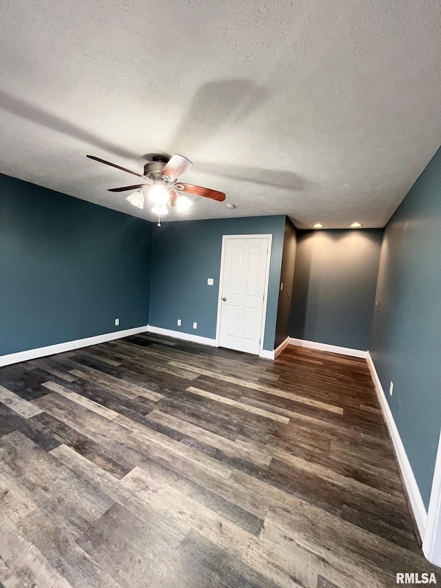 unfurnished bedroom featuring a textured ceiling, dark hardwood / wood-style floors, and ceiling fan