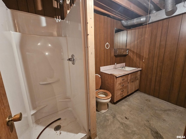 bathroom featuring toilet, concrete flooring, a shower, vanity, and wooden walls