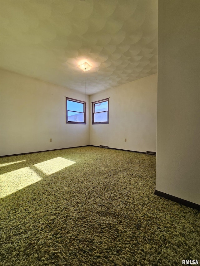 unfurnished room with carpet flooring