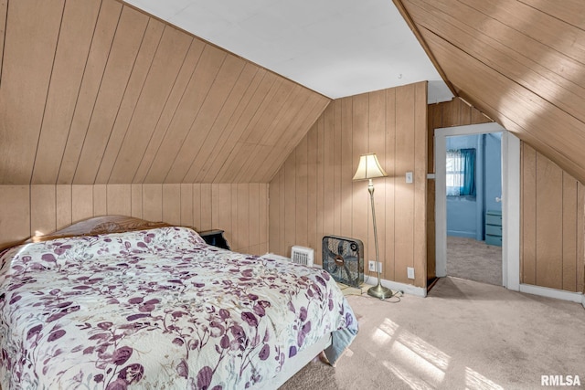 carpeted bedroom featuring wooden walls and vaulted ceiling