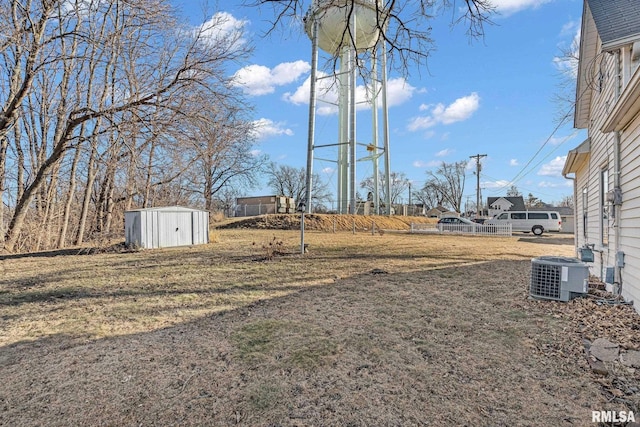 view of yard with a storage unit and central air condition unit