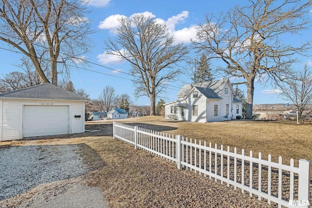 view of home's exterior with a garage, a yard, and an outdoor structure