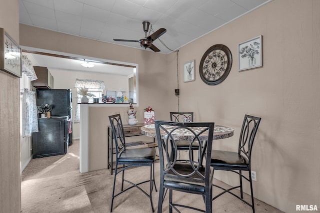 carpeted dining area featuring ceiling fan