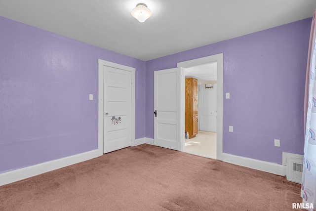 unfurnished bedroom featuring a closet and carpet