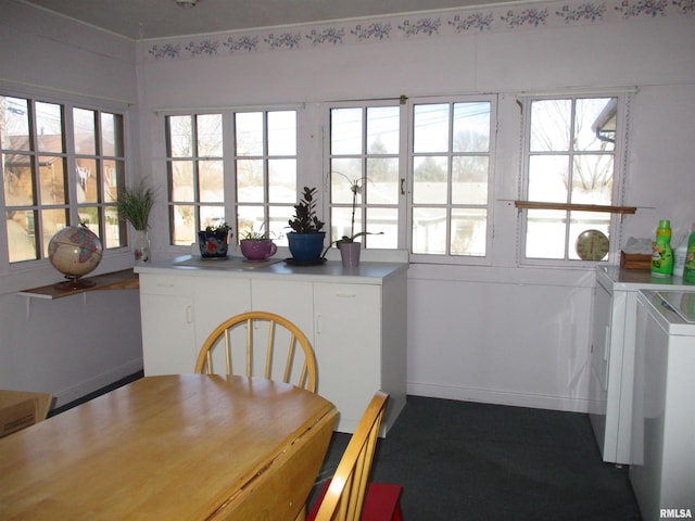 unfurnished dining area with a wealth of natural light and washing machine and clothes dryer