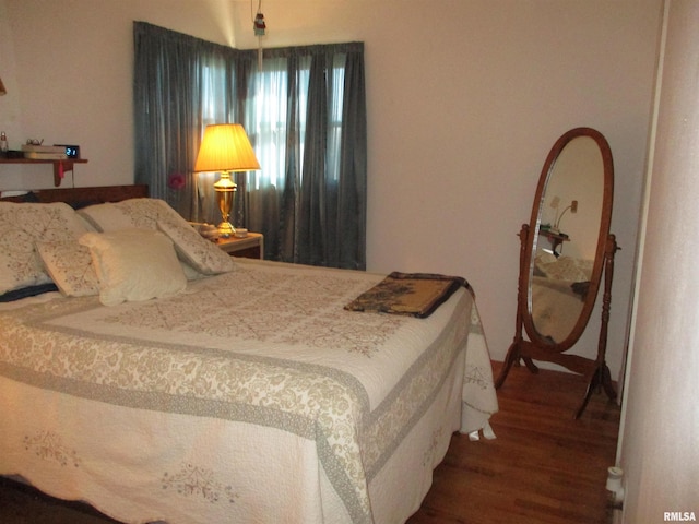 bedroom with hardwood / wood-style floors