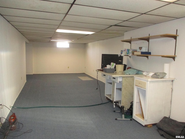 basement with a paneled ceiling