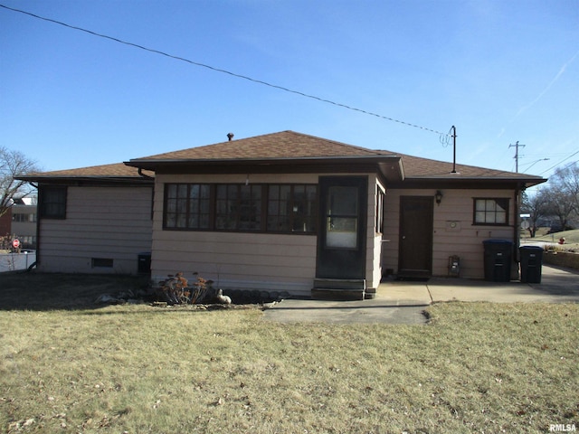 rear view of property with a lawn and a patio