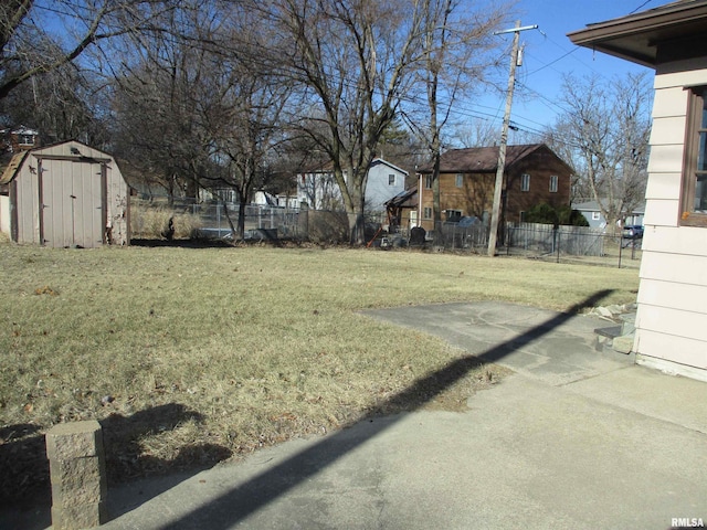 view of yard featuring a patio area and a storage unit