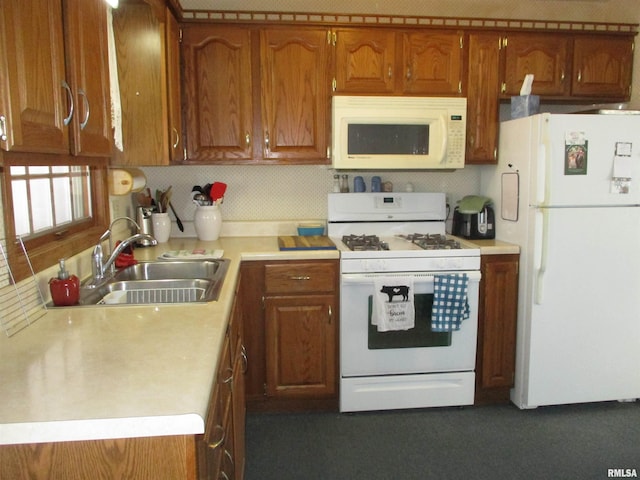 kitchen featuring sink, white appliances, and decorative backsplash