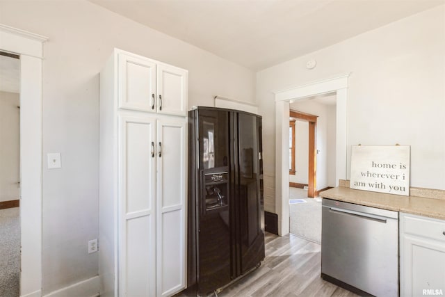 kitchen featuring black refrigerator with ice dispenser, stainless steel dishwasher, light hardwood / wood-style floors, and white cabinets