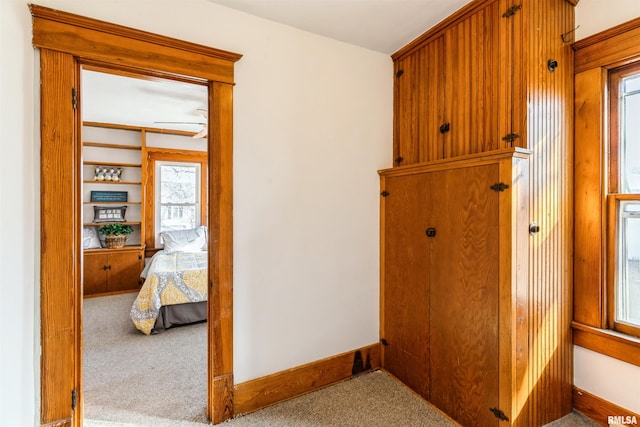 hall with light colored carpet