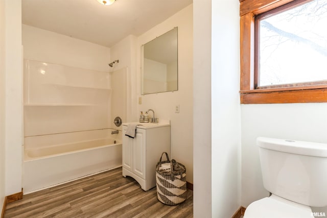 full bathroom with vanity, toilet, bathing tub / shower combination, and hardwood / wood-style floors