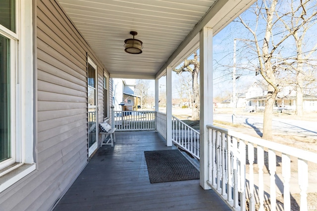 wooden terrace featuring covered porch