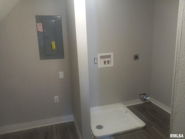 washroom featuring dark hardwood / wood-style flooring, washer hookup, electric panel, and hookup for an electric dryer