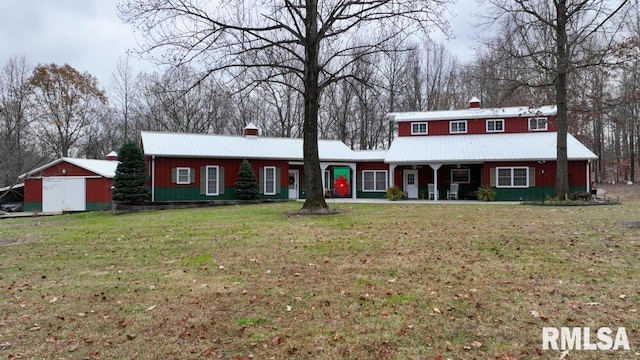 25065 Rock Springs Hollow Rd, Thebes, IL 62990 - view of front of home featuring a porch, a chimney, metal roof, and a front lawn