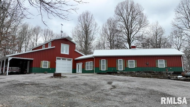 25065 Rock Springs Hollow Rd, Thebes, IL 62990 - view of front facade with a garage, board and batten siding, a chimney, an outdoor structure, and driveway