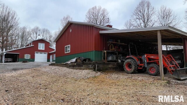 25065 Rock Springs Hollow Rd, Thebes, IL 62990 - view of property exterior with a garage, an outdoor structure, a chimney, and driveway