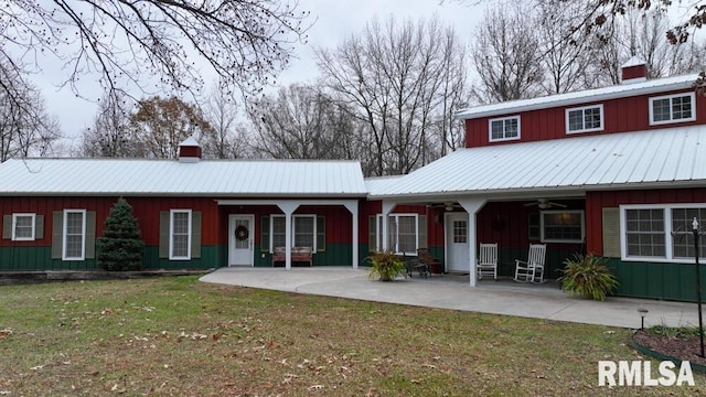 25065 Rock Springs Hollow Rd, Thebes, IL 62990 - back of house with a ceiling fan, a yard, and a chimney
