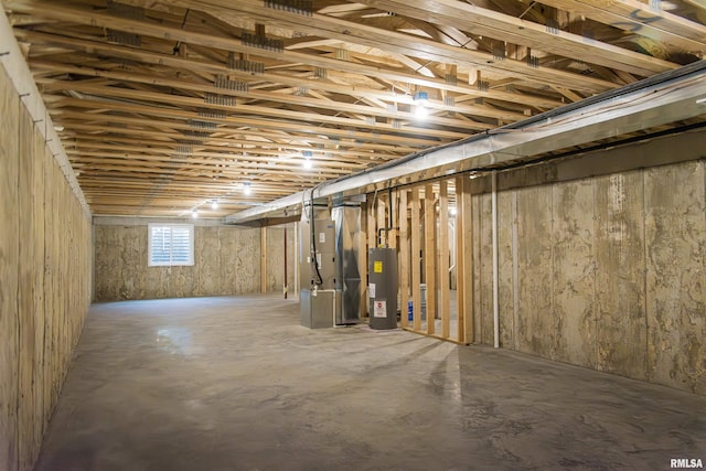 basement featuring heating unit and water heater