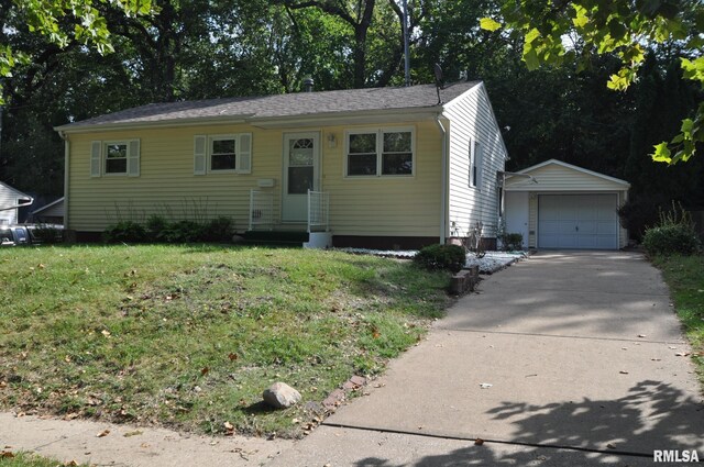 view of front of house with an outbuilding, a garage, and a front yard