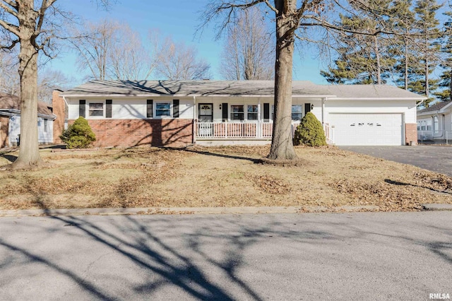 ranch-style home with a garage and a porch