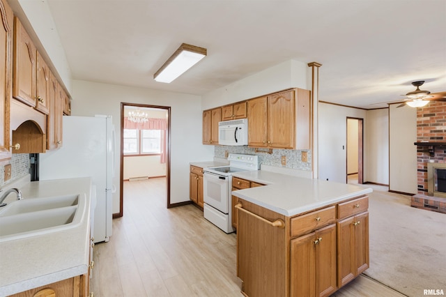 kitchen with a fireplace, sink, decorative backsplash, ceiling fan, and white appliances