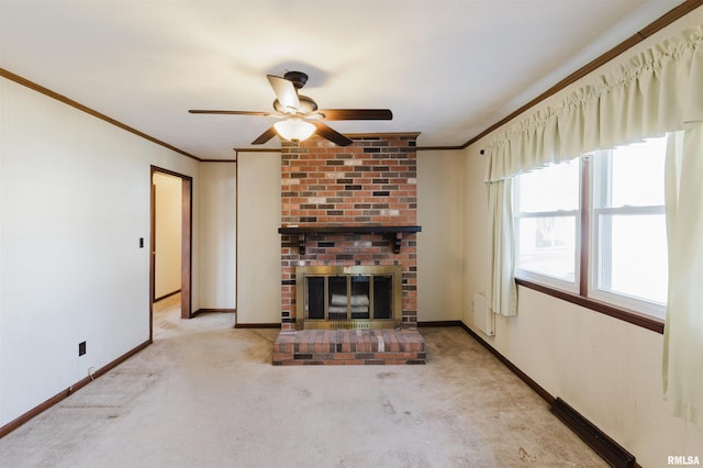 unfurnished living room with ornamental molding, a brick fireplace, light carpet, and ceiling fan