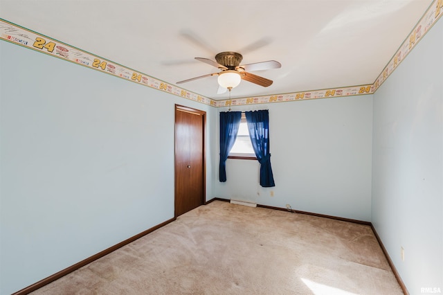 carpeted empty room with ceiling fan