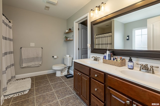 bathroom featuring vanity, tile patterned floors, and toilet