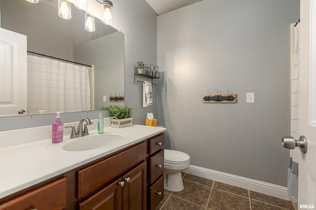 bathroom with vanity, tile patterned floors, and toilet