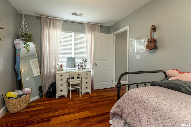 bedroom with dark wood-type flooring