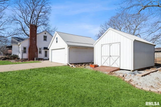 view of outbuilding featuring a garage and a lawn