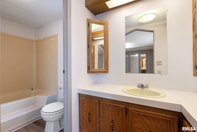 full bathroom with shower / tub combination, vanity, toilet, and a textured ceiling