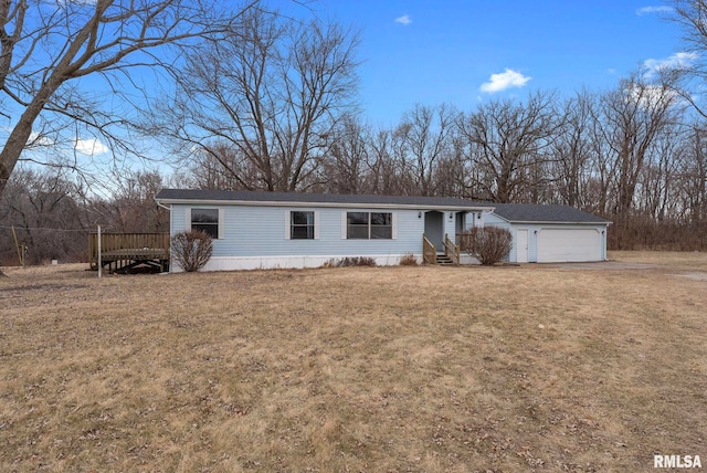 manufactured / mobile home with a garage and a front lawn