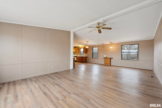 unfurnished living room featuring ceiling fan, light hardwood / wood-style flooring, and a healthy amount of sunlight